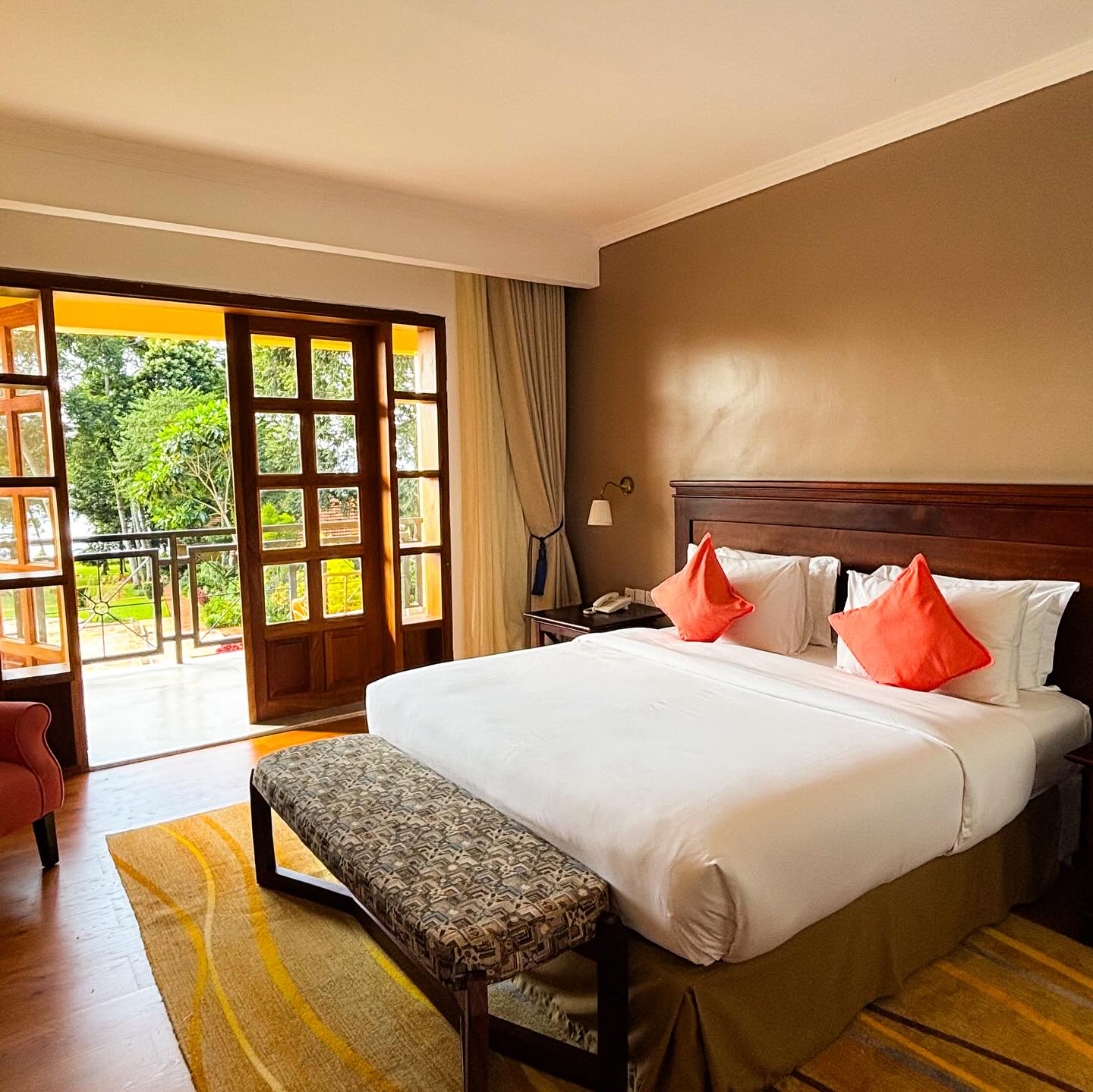 Deluxe room with a king bed and balcony doors open